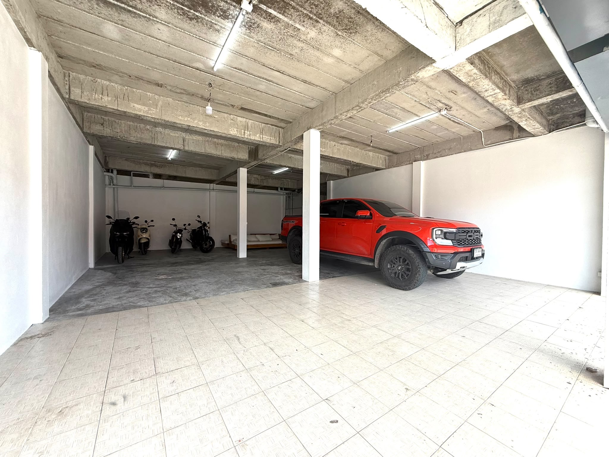 Covered indoor car storage with a Ford Ranger Raptor parked inside