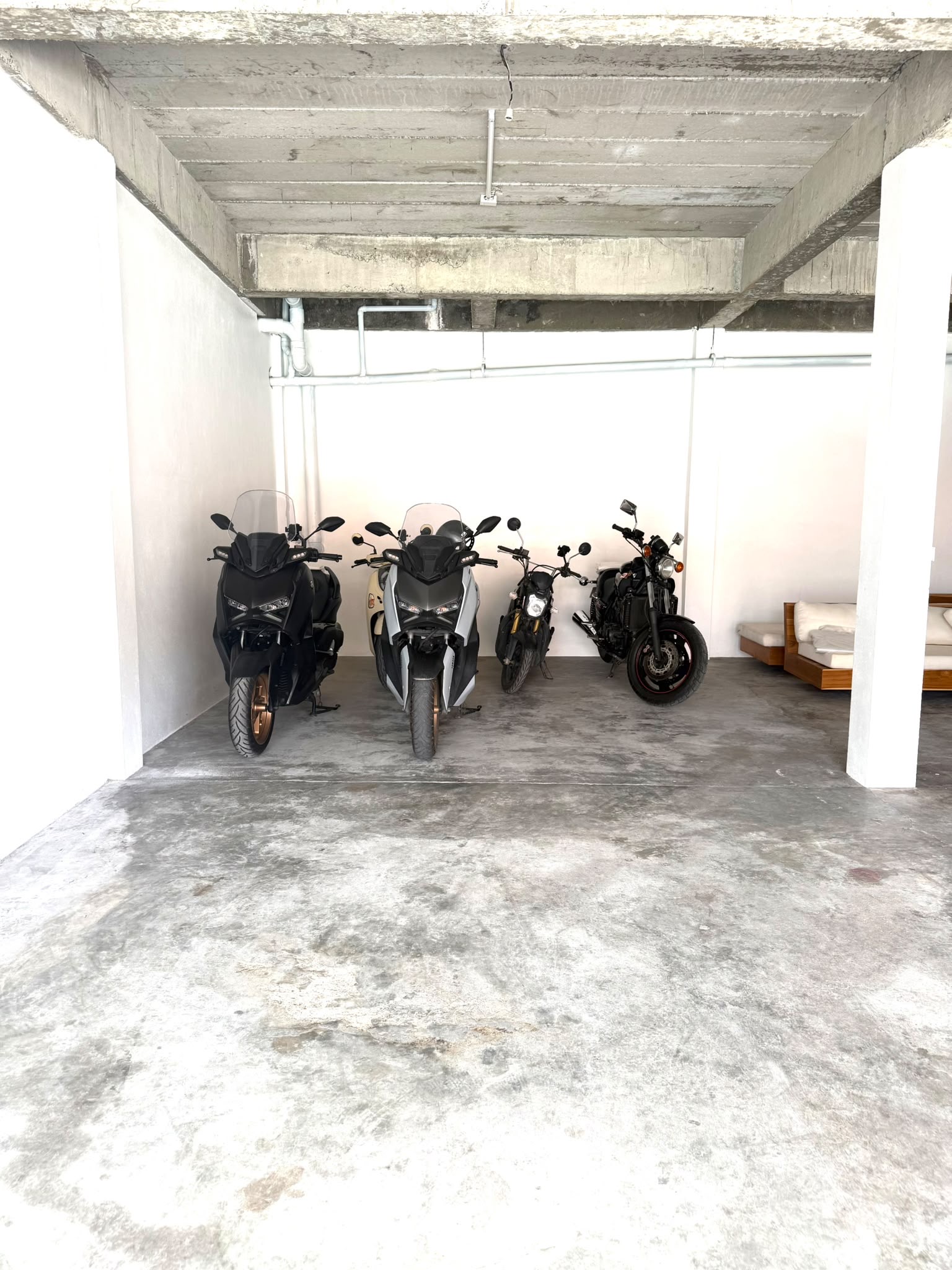 Scooters and motorbikes lined up in dedicated indoor parking